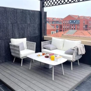 Outdoor seating area with two white sofas and a coffee table