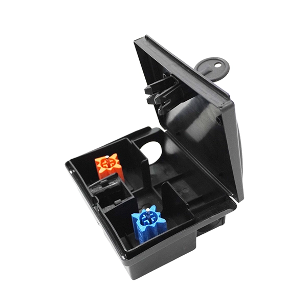 Open black mouse bait station showing interior compartments with orange and blue bait blocks for secure rodent control.