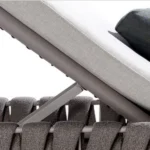 Close-up of woven backrest and cushion detail on an outdoor chair.