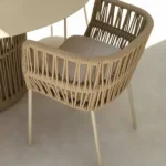 Outdoor woven armchair with a natural wood finish and a cushioned seat