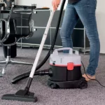 Industrial Wet and Dry Vacuum Cleaner in action on carpeted office flooring.