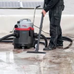 Industrial Wet and Dry Vacuum Cleaner in action, cleaning a waterlogged area.