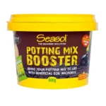 Seasol Potting Mix Booster 500g container with yellow lid and dark background showing soil microbes