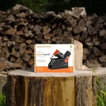 GoodNature Smart Trap Kit for pest control in Australia, displayed outdoors on a tree stump.