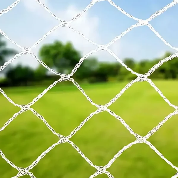 White diamond mesh bird netting draped over fruit trees in a garden, protecting the harvest.